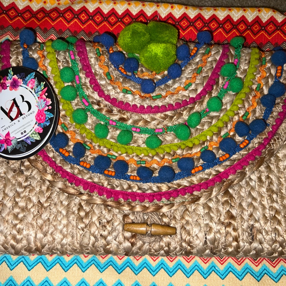Never Used 	
Pompom Fiesta Jute Clutch